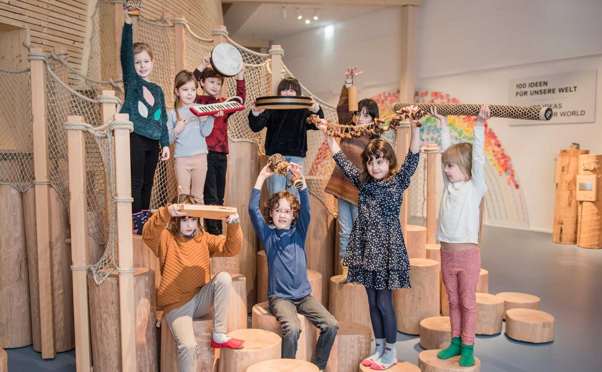The picture shows a group of children holding up objects.