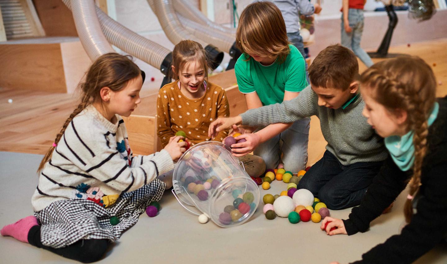 Children play with felt balls