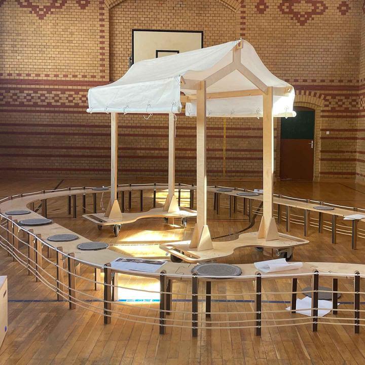 Ark assembled from wooden elements in a gymnasium.